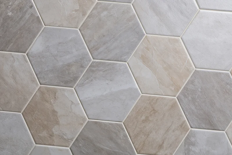 Hexagonal ceramic tiles arranged in a seamless pattern on a floor or wall surface