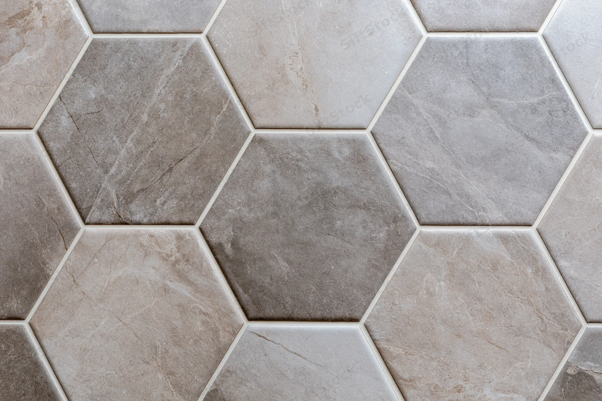 Hexagonal ceramic tiles arranged in a geometric pattern on a floor or wall surface