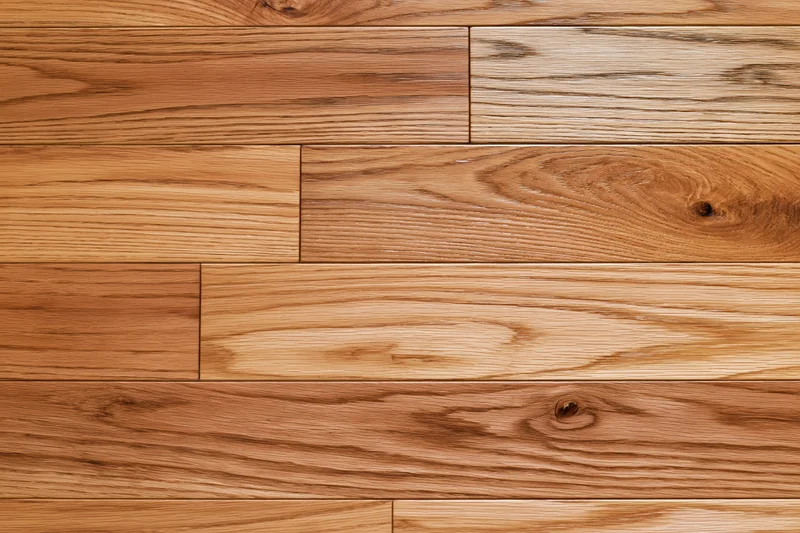 Hardwood parquet flooring arranged in staggered planks filling the frame