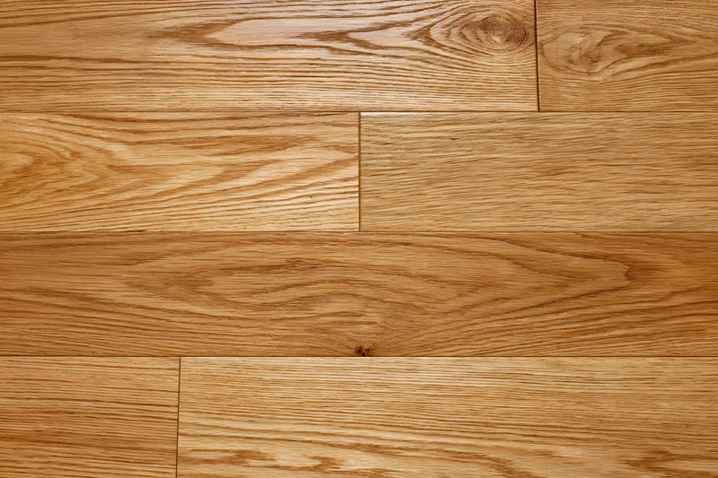 Close-up of hardwood parquet flooring with visible wood grain and plank pattern filling the frame