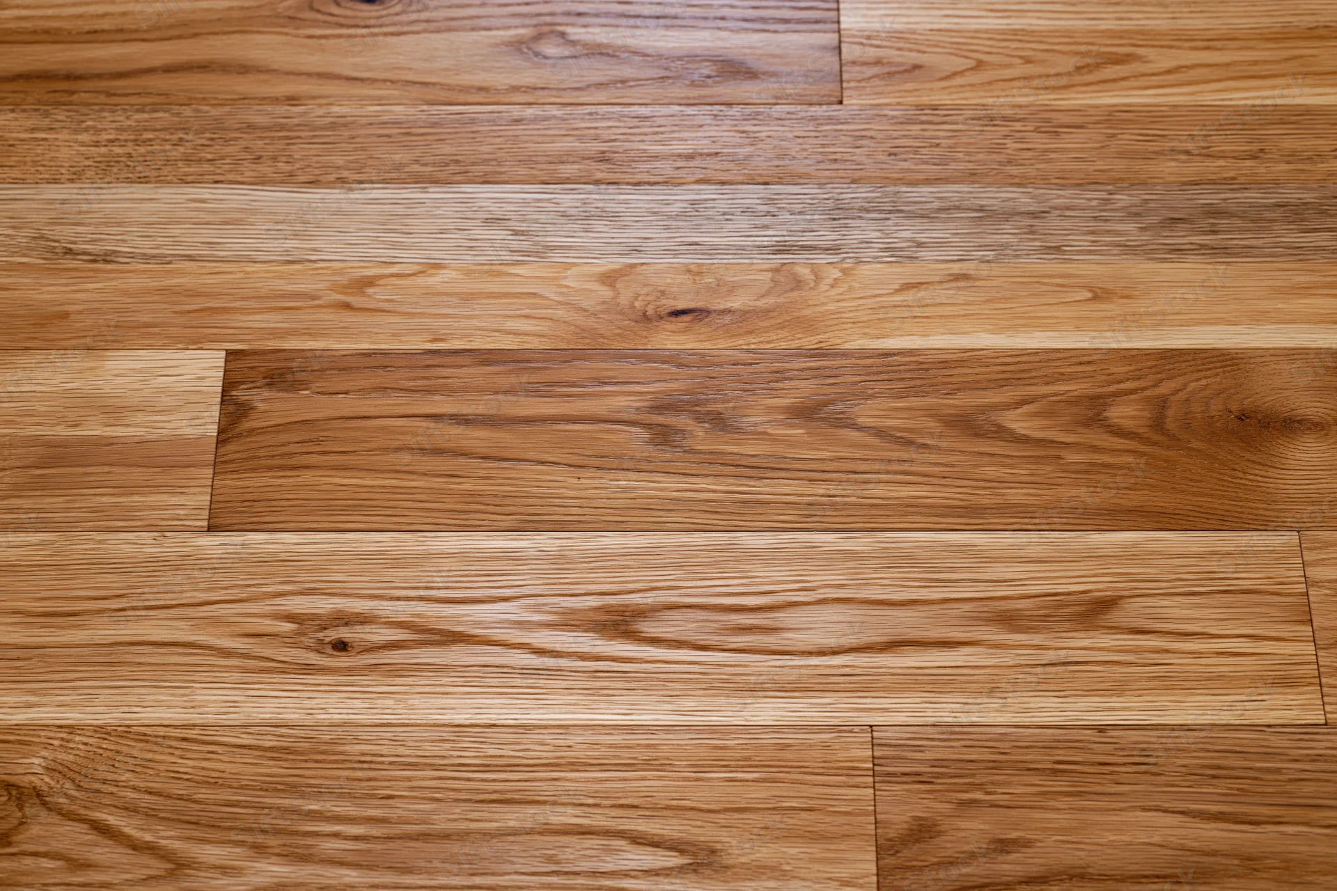 Close-up of hardwood parquet flooring with visible wood grain and plank arrangement filling the frame