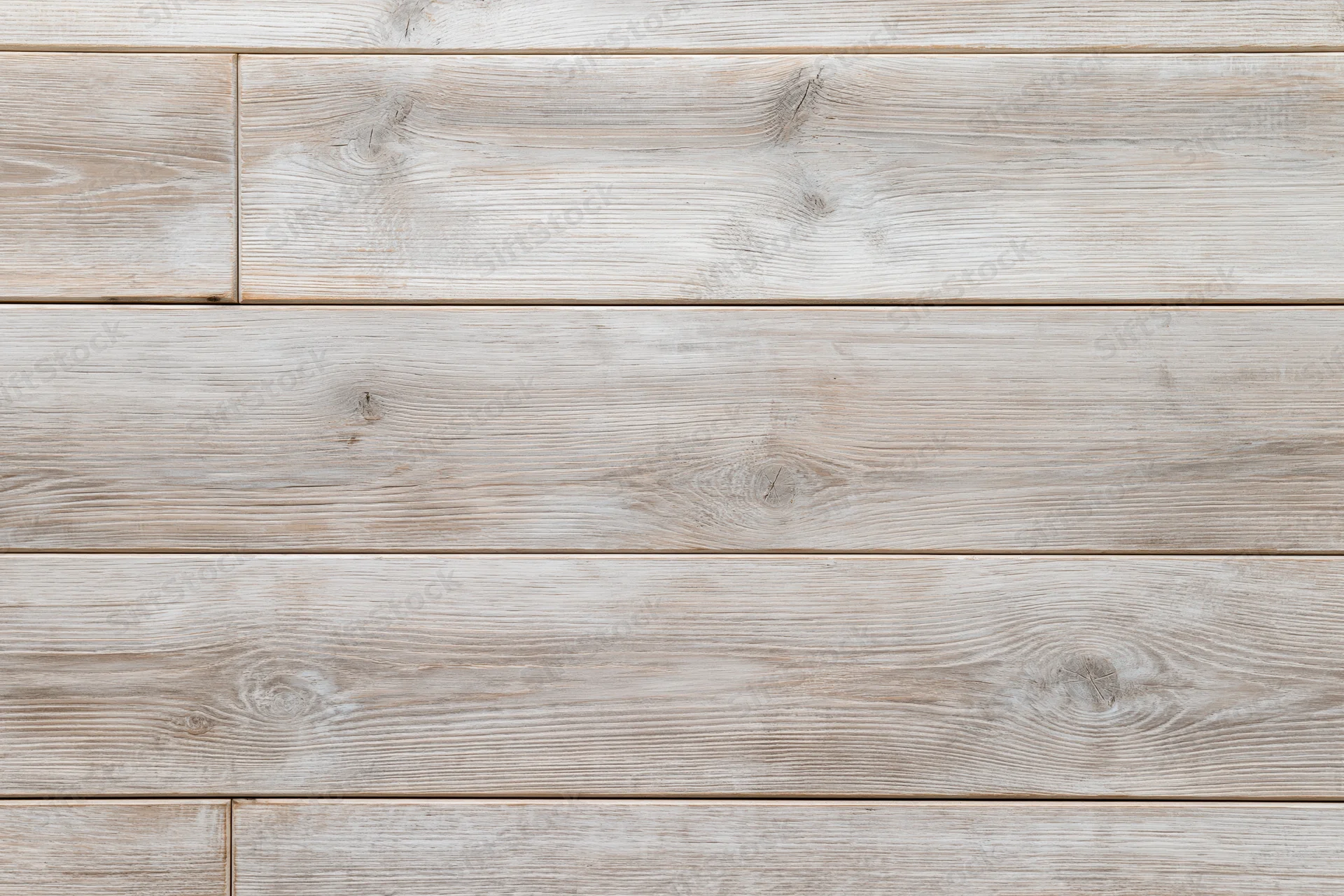Close-up flat lay of light grey-beige hardwood floor planks arranged horizontally with visible wood grain and knots