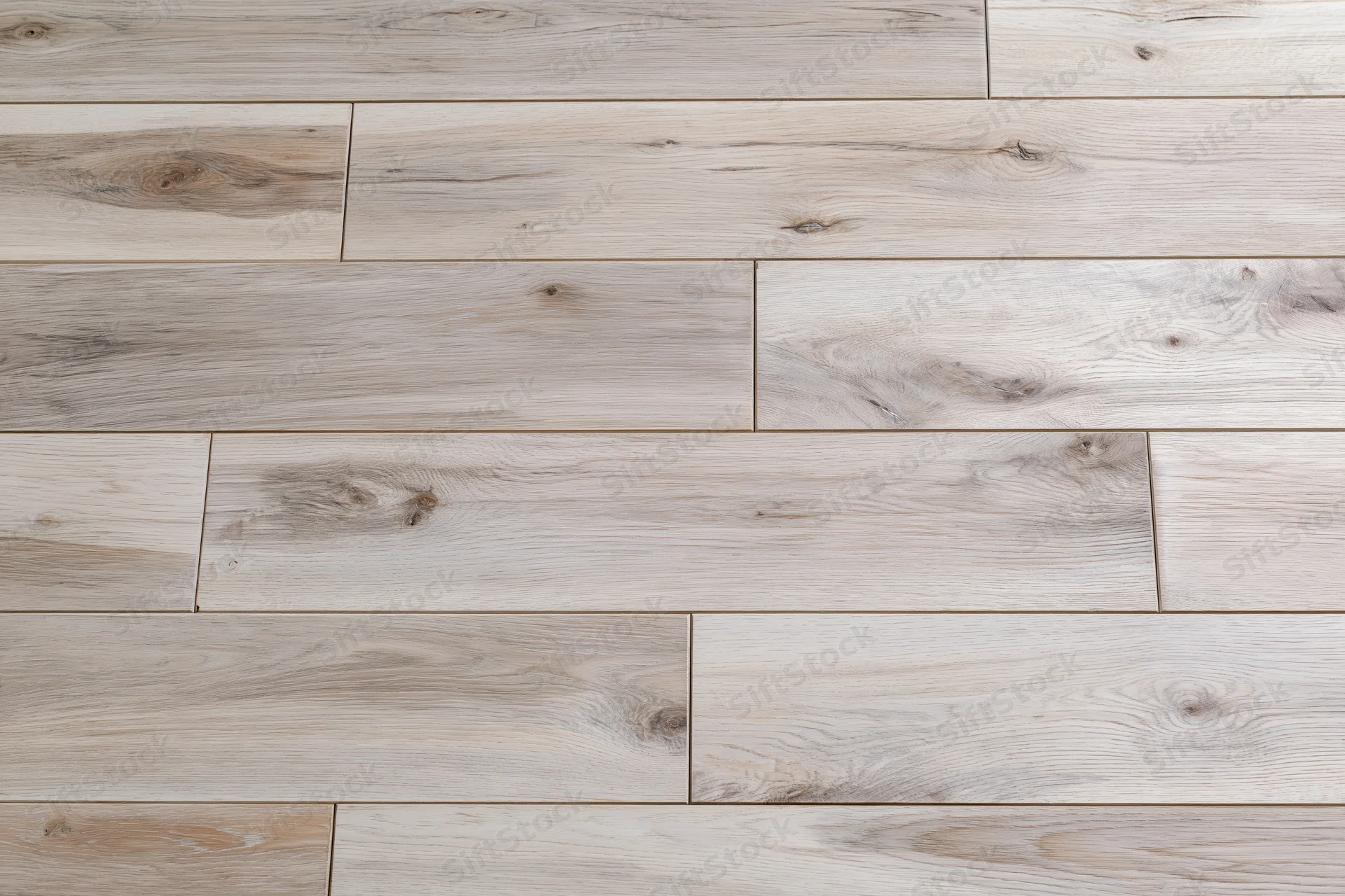 Close-up flat lay of light grey-beige hardwood floor planks arranged in staggered pattern