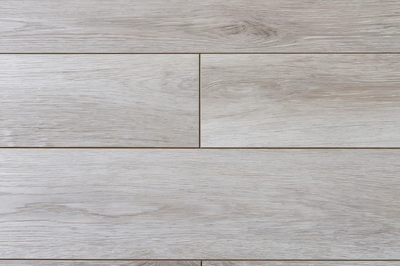 Close-up flat lay of light grey-beige oak hardwood flooring planks arranged in horizontal rows with visible wood grain and joints