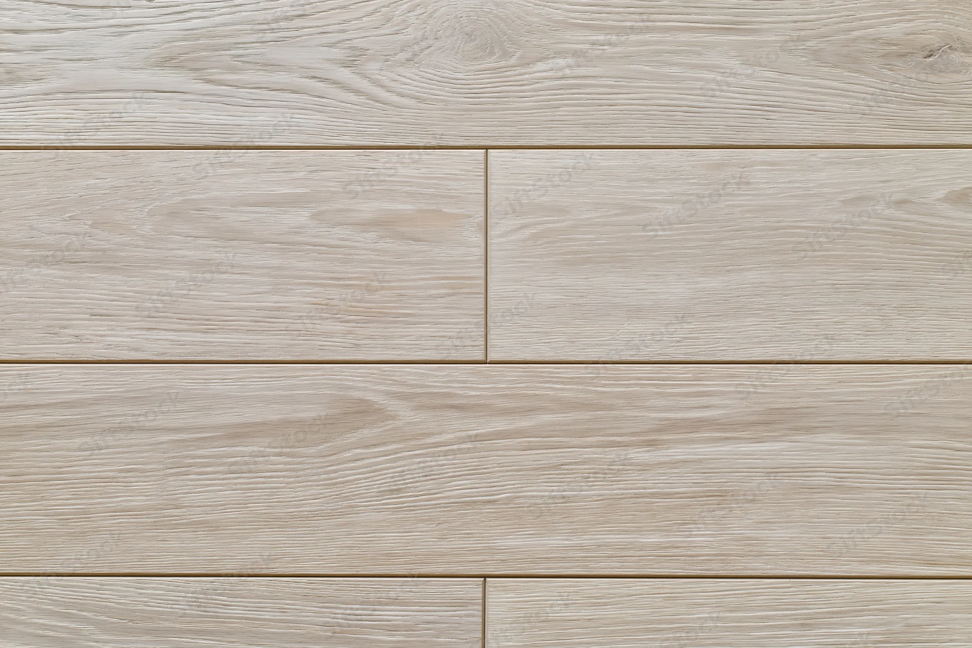 Close-up flat lay of light grey-beige oak hardwood flooring planks arranged in staggered pattern on interior floor surface