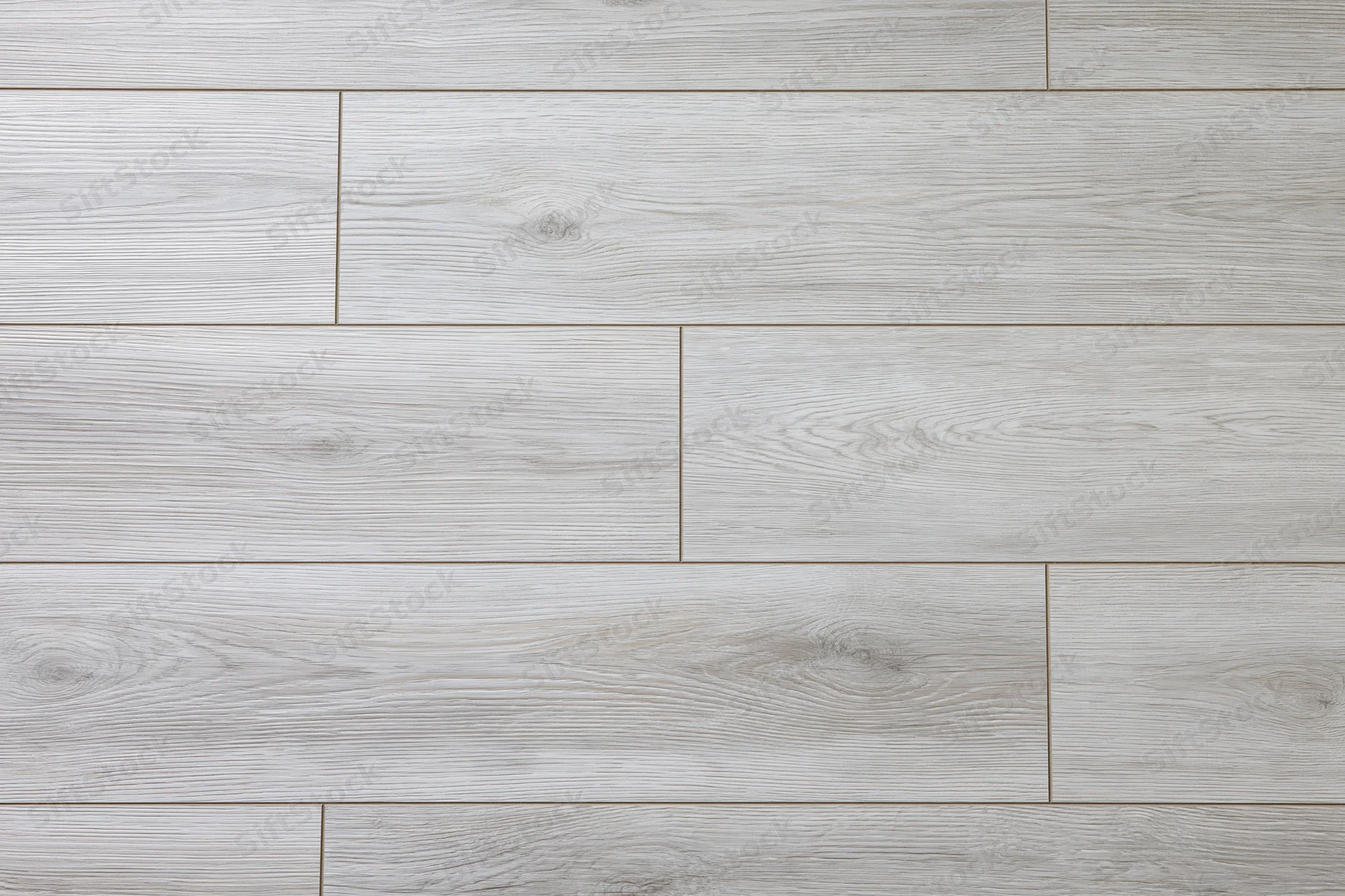 Light grey oak laminate flooring planks arranged in a flat lay pattern for interior design