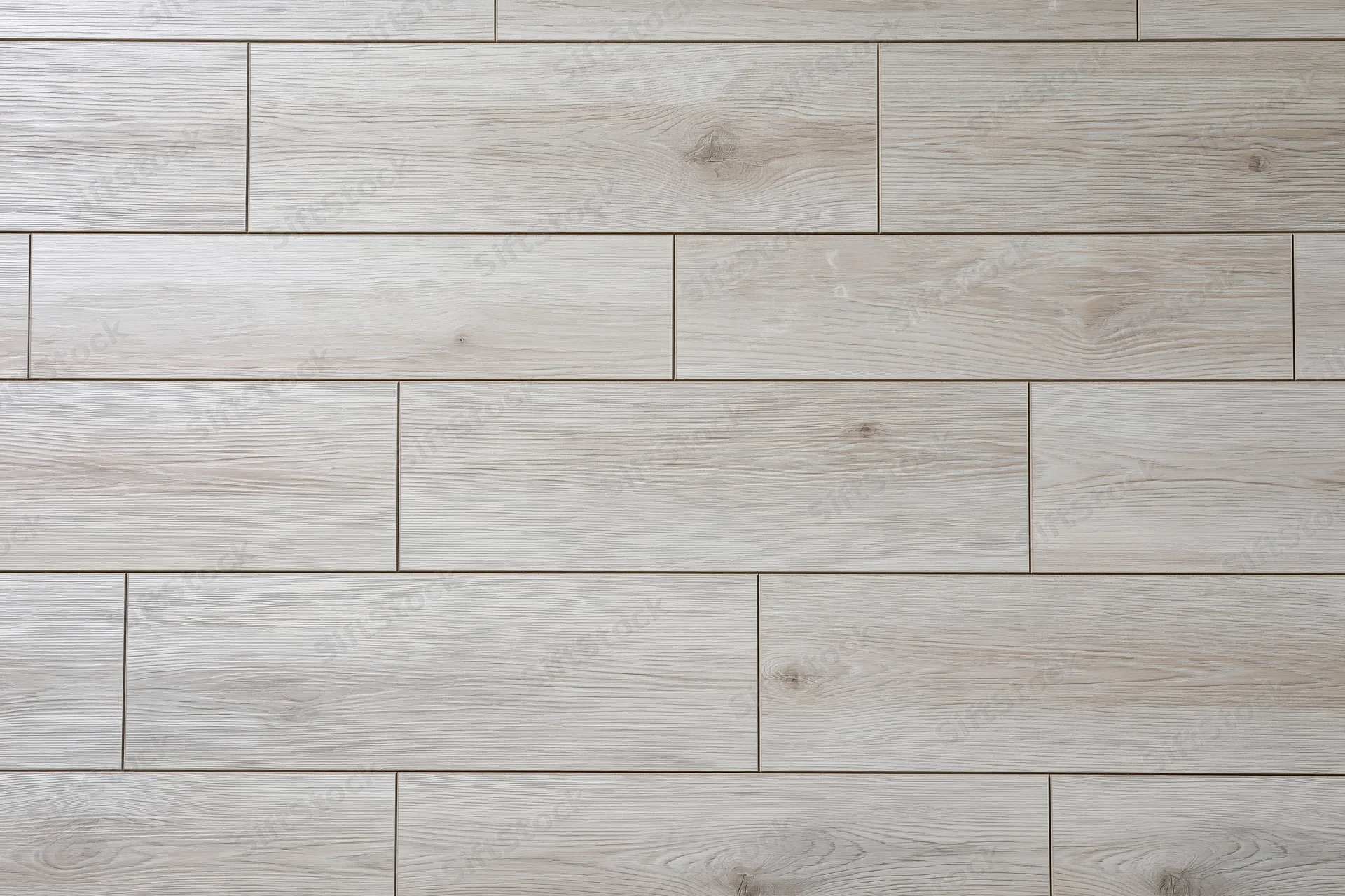 Light grey oak laminate flooring planks arranged in staggered pattern for interior flooring