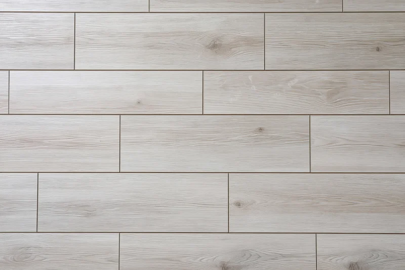 Light grey oak laminate flooring planks arranged in staggered pattern for interior flooring