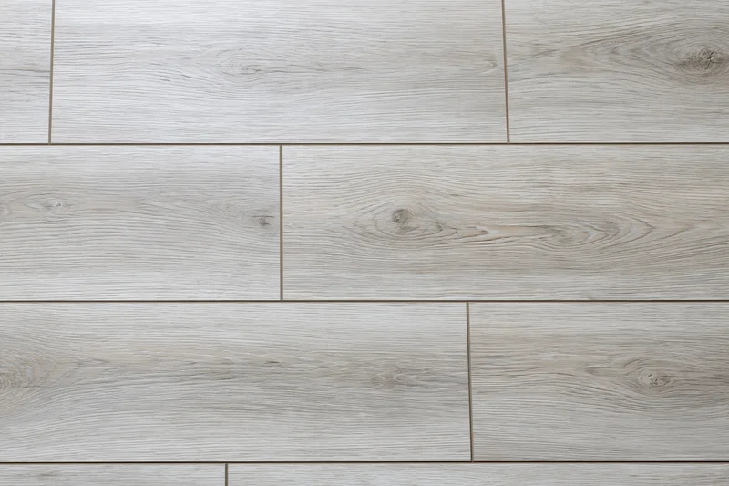 Light grey oak laminate flooring planks arranged in horizontal pattern for interior flooring
