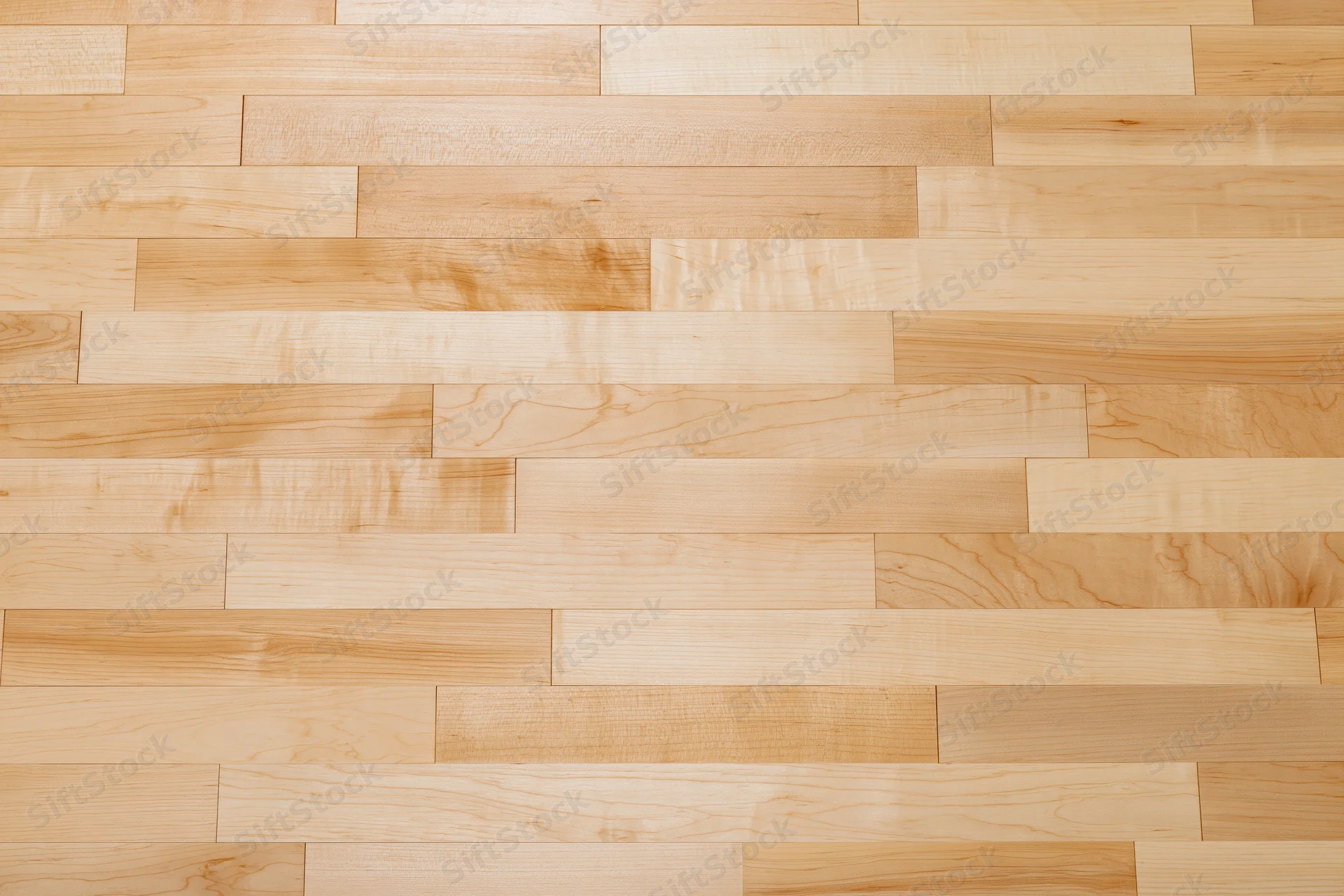 Close-up flat lay of light maple hardwood floor planks arranged in horizontal rows with visible wood grain and natural texture