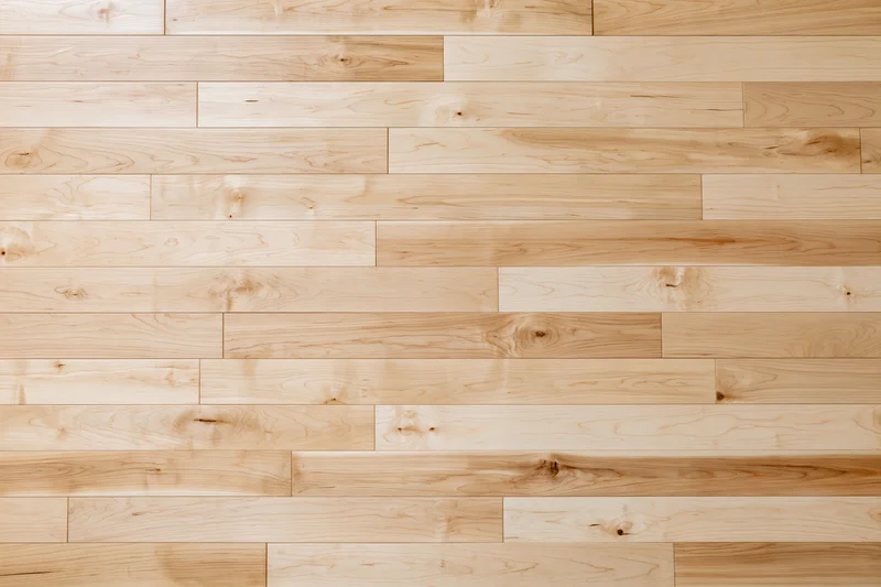Light maple hardwood flooring planks arranged in horizontal rows for interior flooring