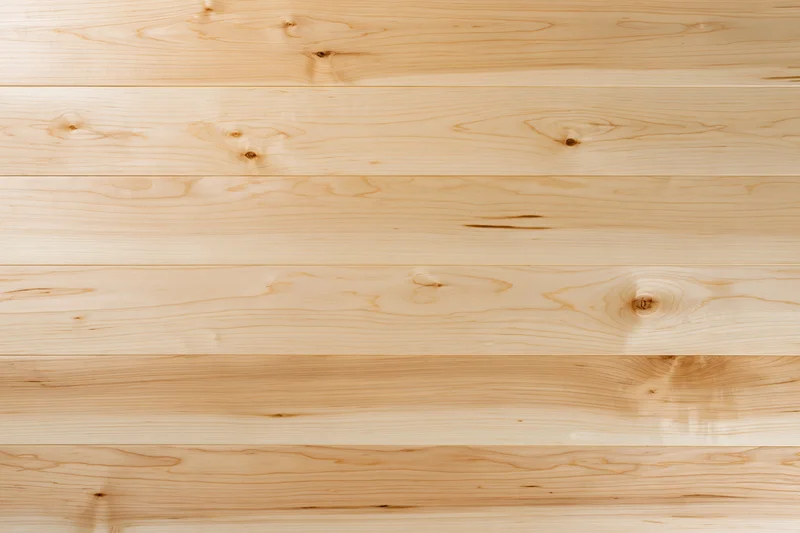 Light maple hardwood flooring planks arranged horizontally in a flat lay view