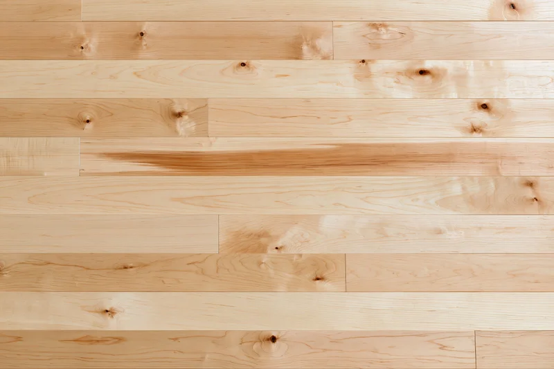 Light maple hardwood flooring planks arranged horizontally in a flat lay view