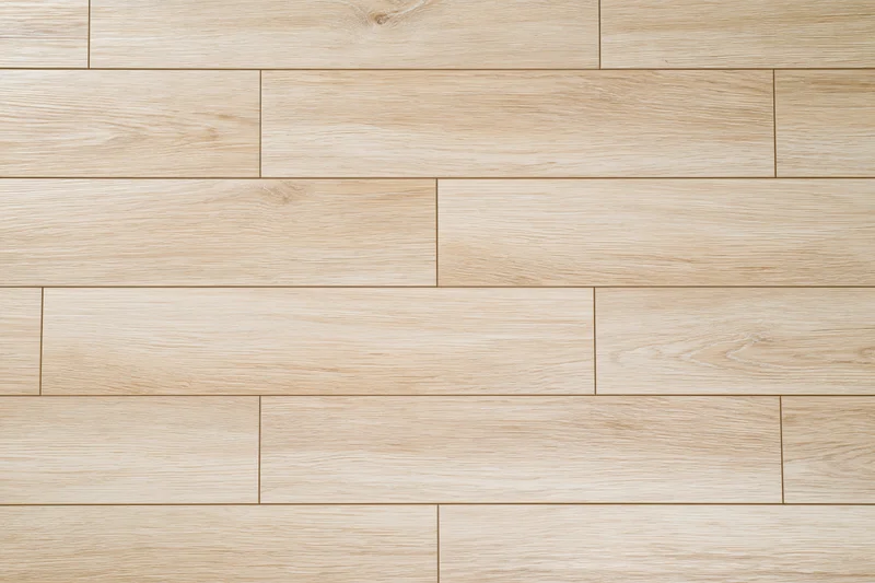 Light oak hardwood floor planks arranged in staggered pattern for interior flooring