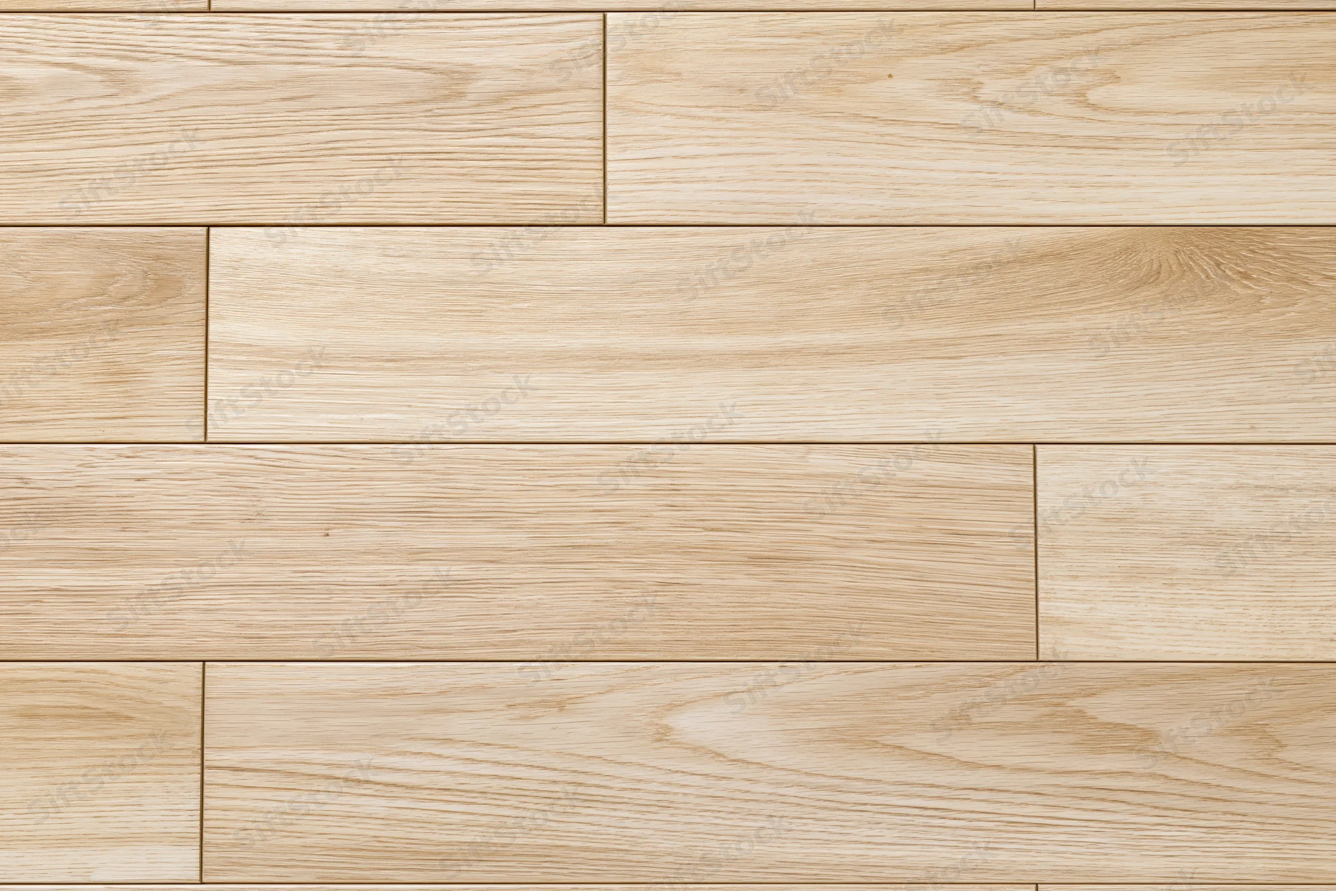 Light oak hardwood floor planks arranged in staggered pattern for interior flooring