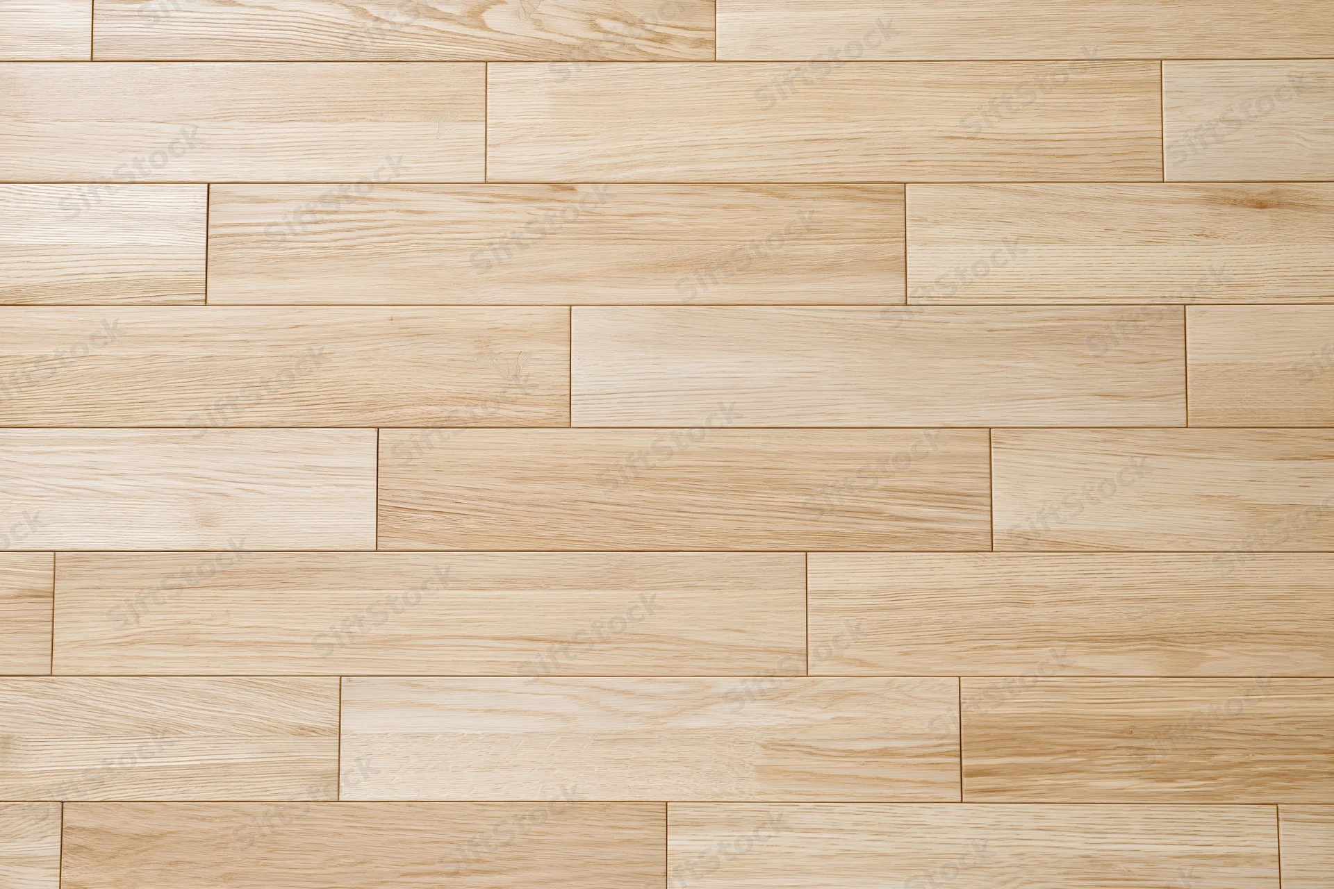 Light oak hardwood floor planks arranged in staggered pattern for interior flooring