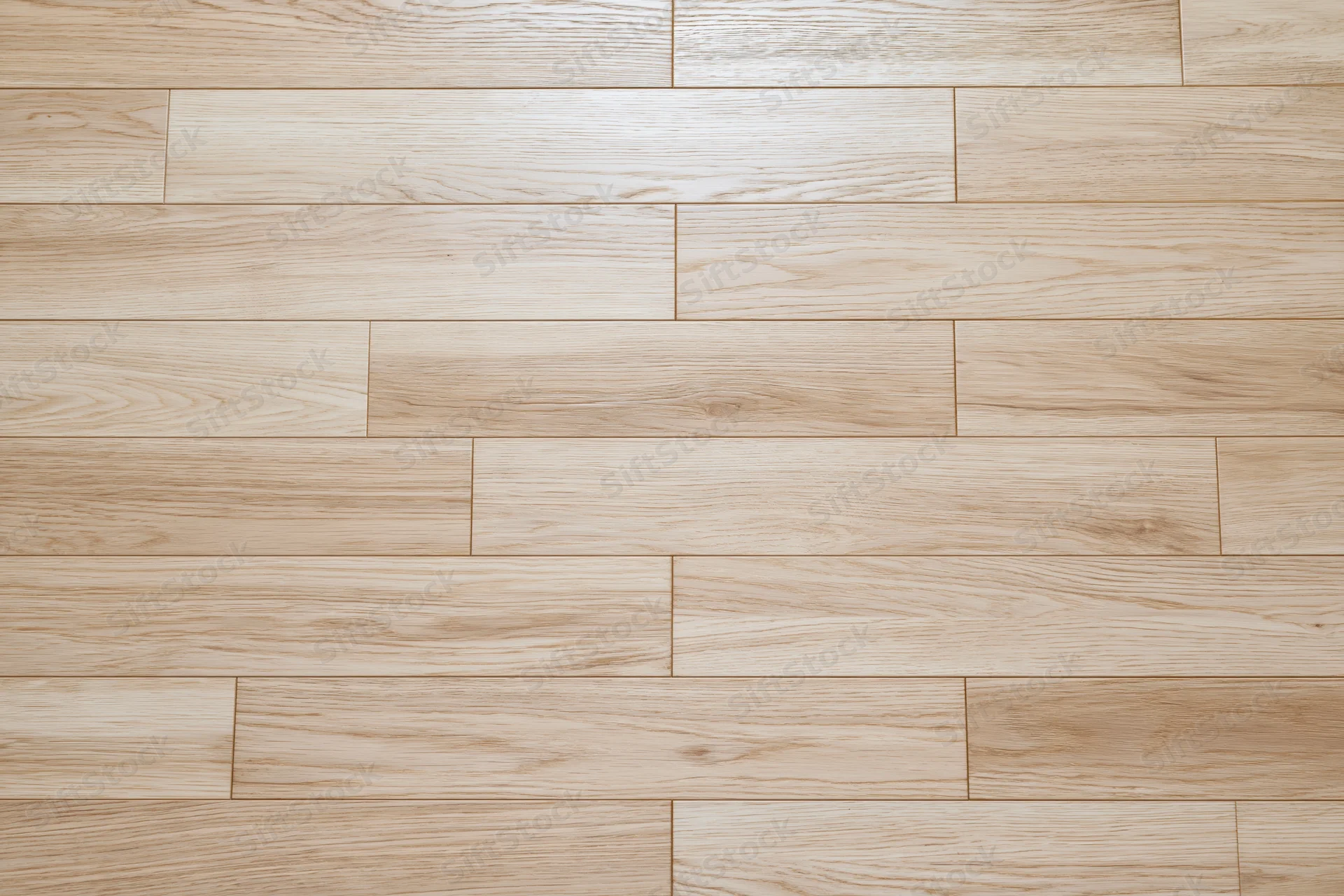 Light oak hardwood floor planks arranged in staggered pattern for interior flooring