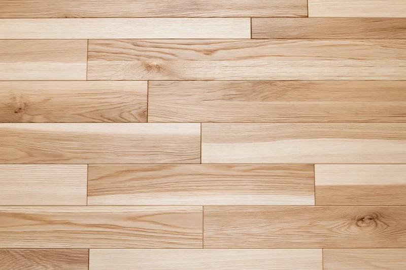 Light oak hardwood flooring planks arranged in a flat lay pattern for interior flooring