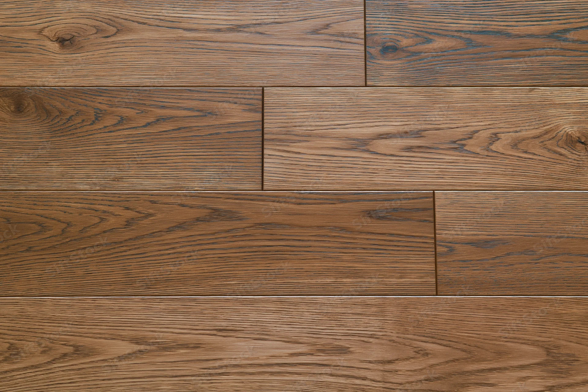 Close-up flat lay of medium brown oak hardwood flooring planks arranged in staggered pattern