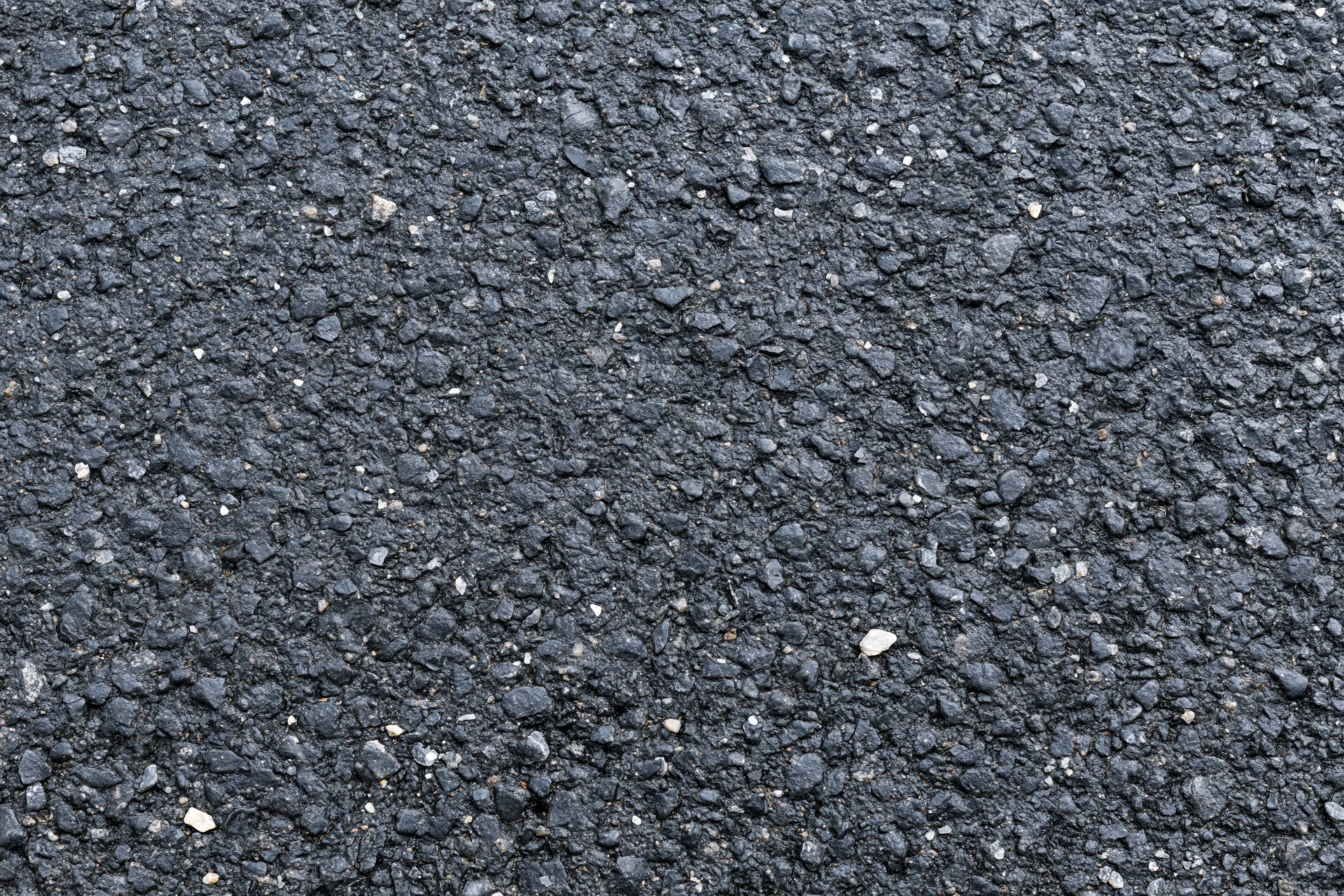 Close-up of rough asphalt pavement surface filling the frame