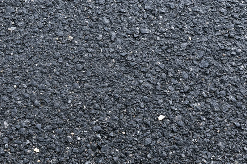 Close-up of rough asphalt pavement surface filling the frame