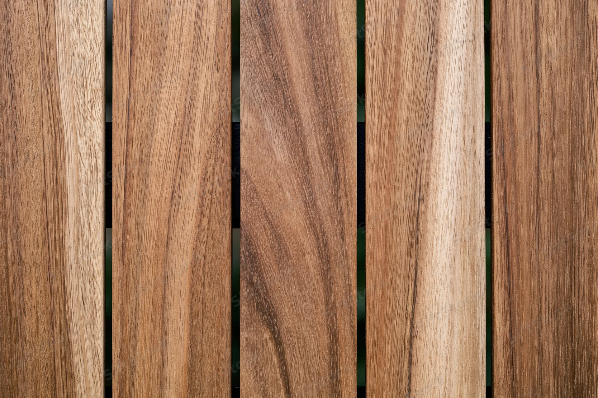 Vertical teak wood planks arranged side by side in a flat lay close-up view