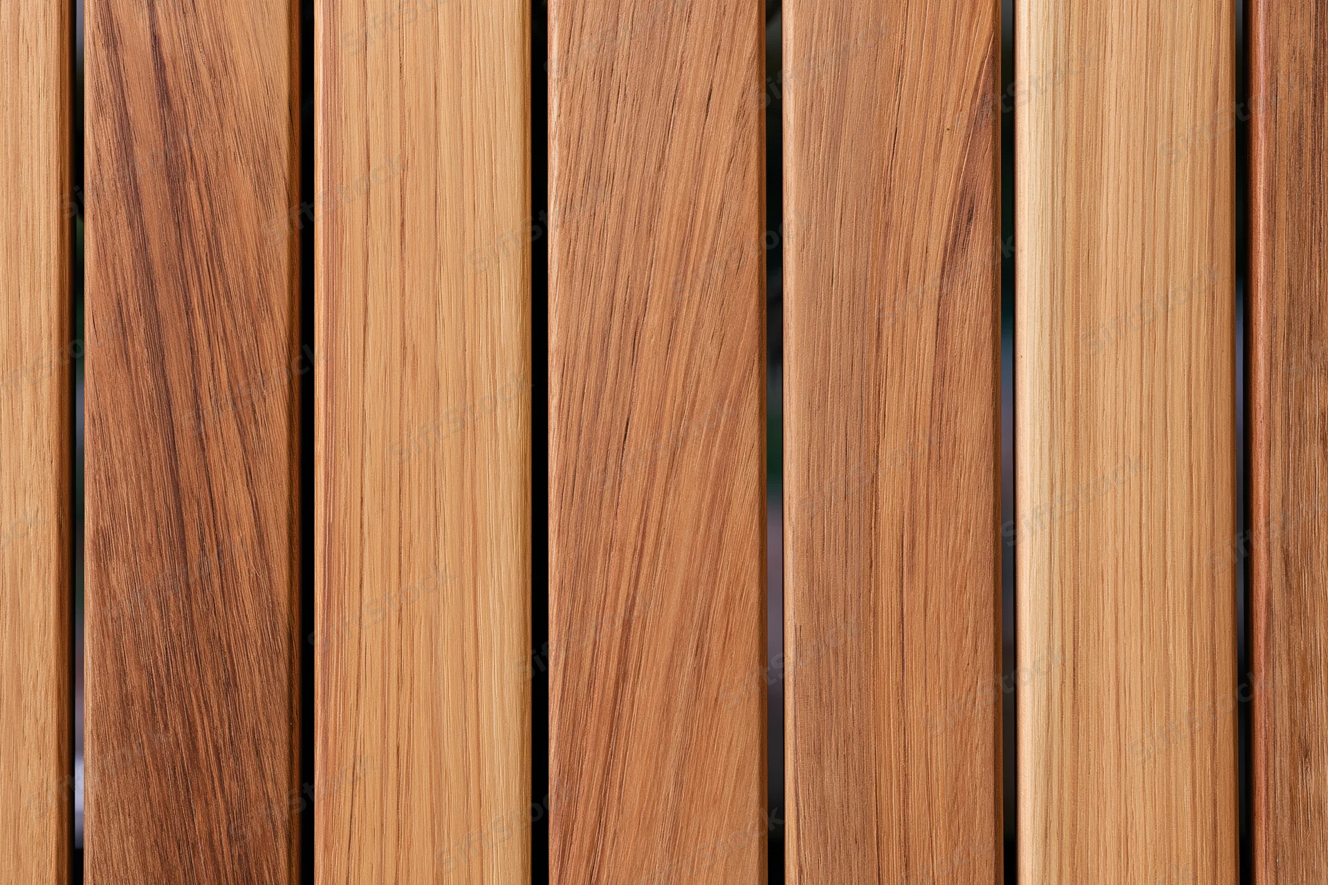 Vertical teak wood planks arranged side by side in a flat lay closeup view
