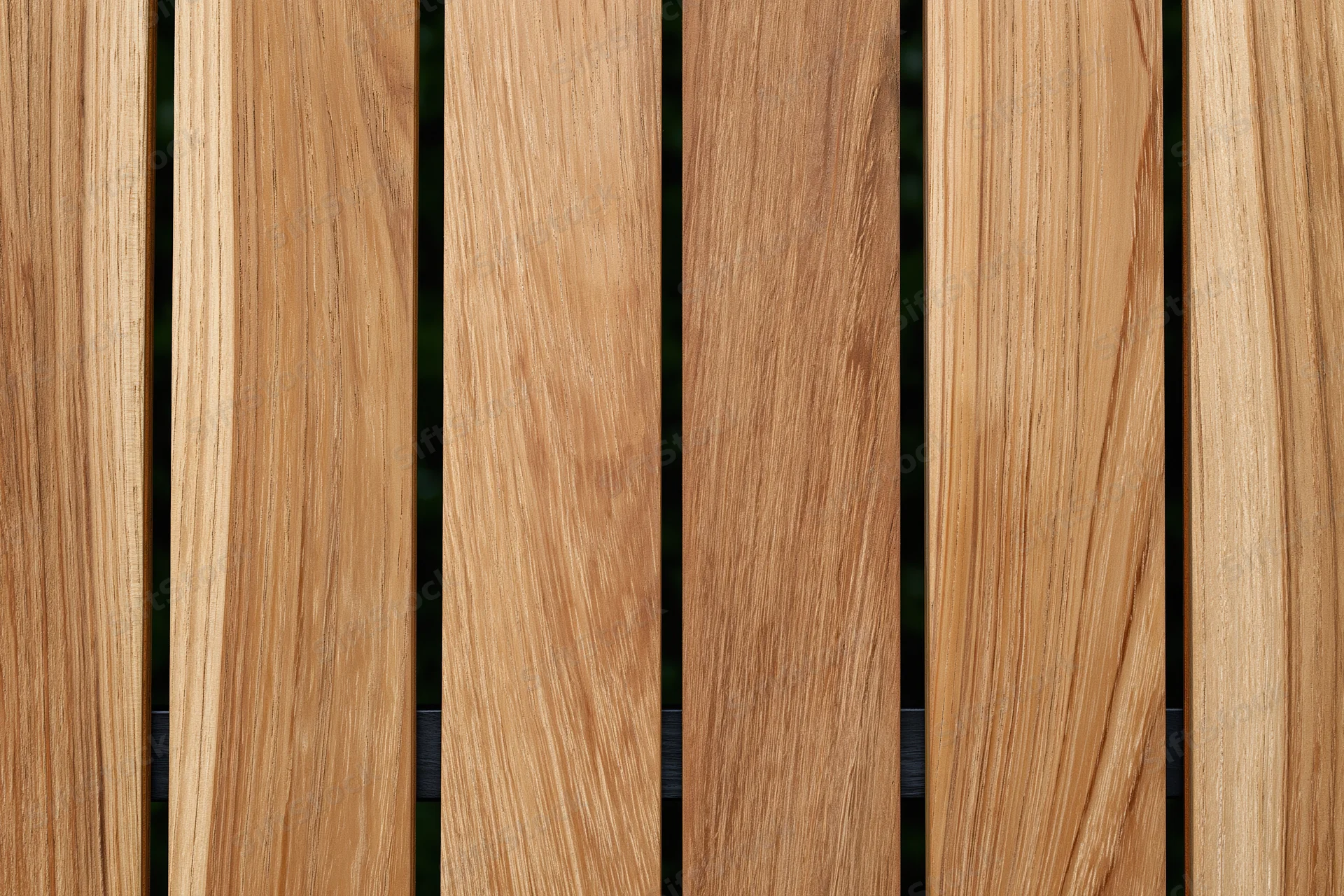 Vertical teak wood planks arranged side by side in a flat lay closeup view