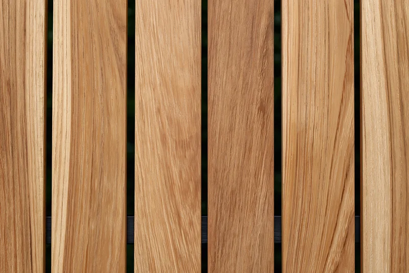 Vertical teak wood planks arranged side by side in a flat lay closeup view