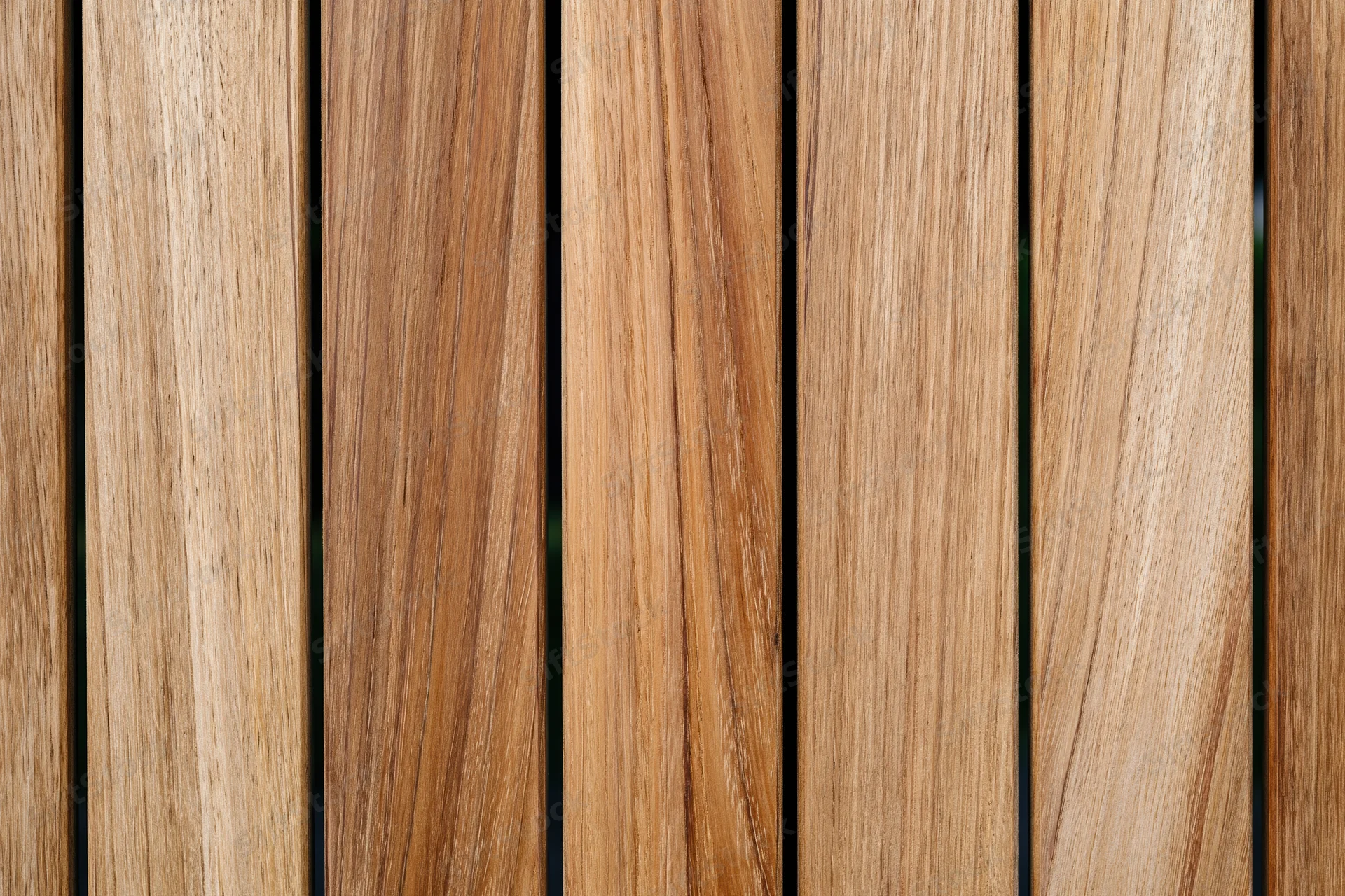 Vertical teak wood planks arranged side by side in a flat lay closeup
