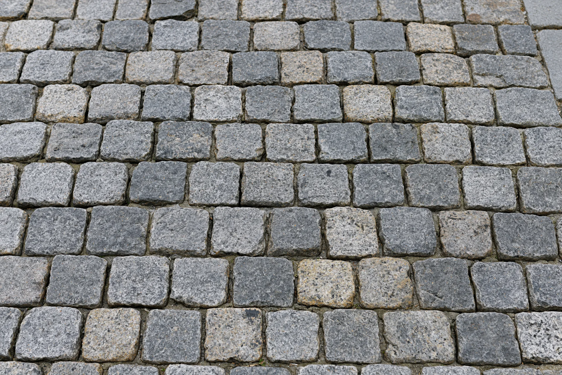 Cobblestone pavement surface viewed from directly above in a flat overhead shot