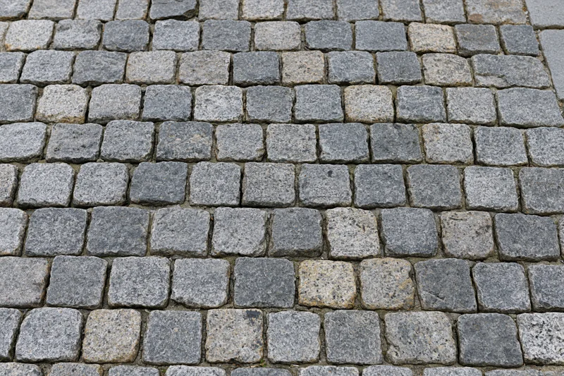 Cobblestone pavement surface viewed from directly above in a flat overhead shot