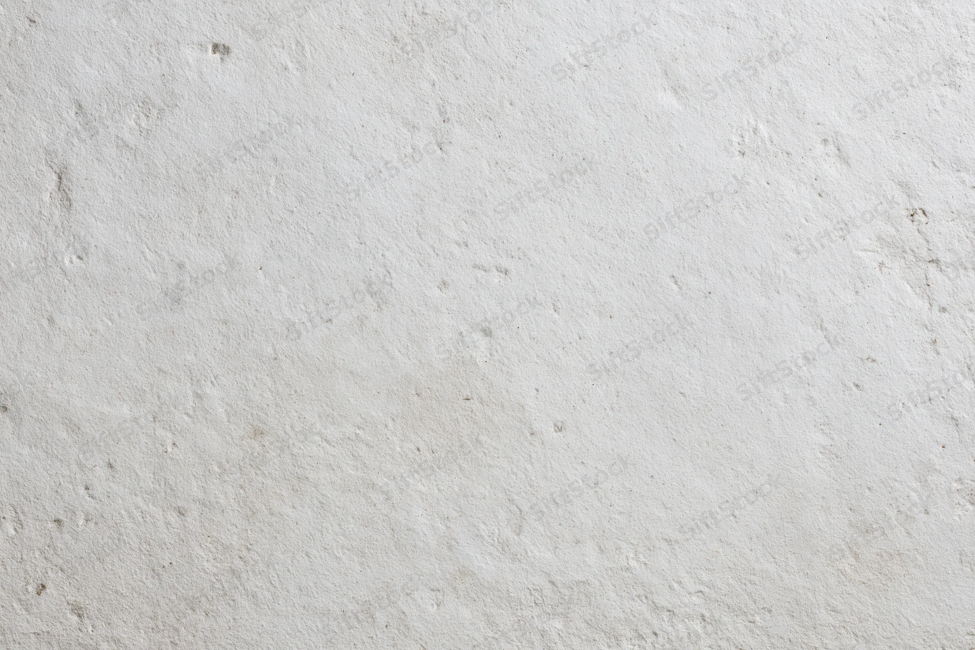 Smooth concrete wall surface filling the frame with even texture and neutral tone