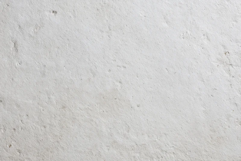 Smooth concrete wall surface filling the frame with even texture and neutral tone