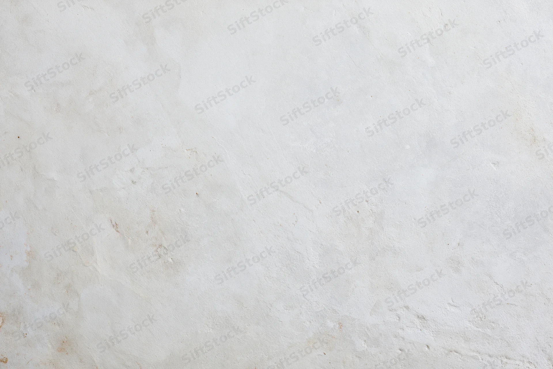 Smooth concrete wall surface filling the frame with even texture and neutral tone