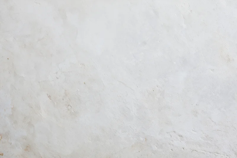 Smooth concrete wall surface filling the frame with even texture and neutral tone