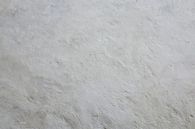 Smooth concrete wall surface filling the frame as a neutral background