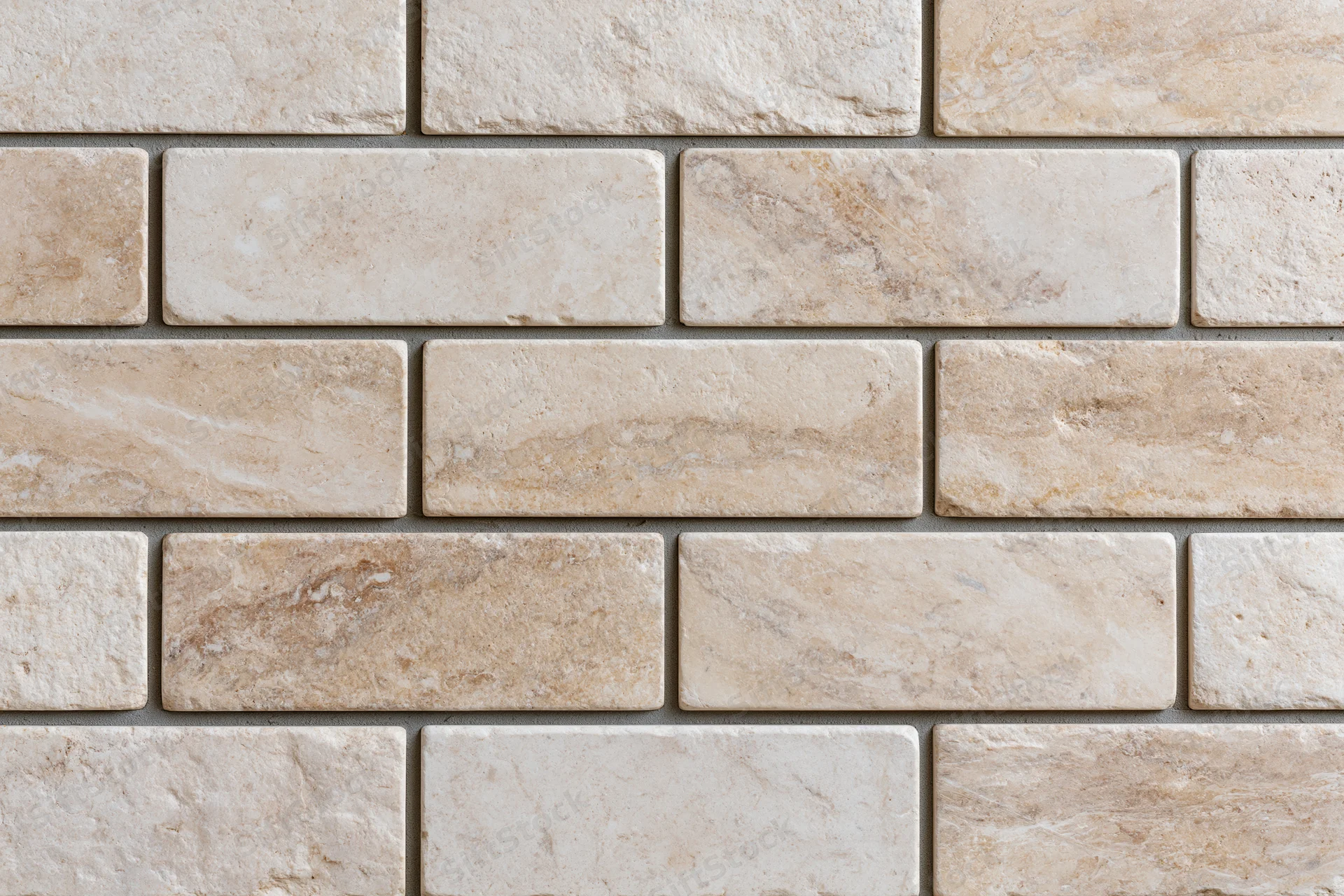 Rectangular travertine stone tiles arranged in a staggered pattern on a wall surface