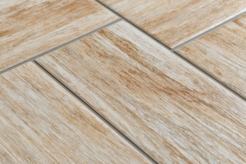 Diagonal ceramic floor tiles with wood grain pattern arranged in staggered layout