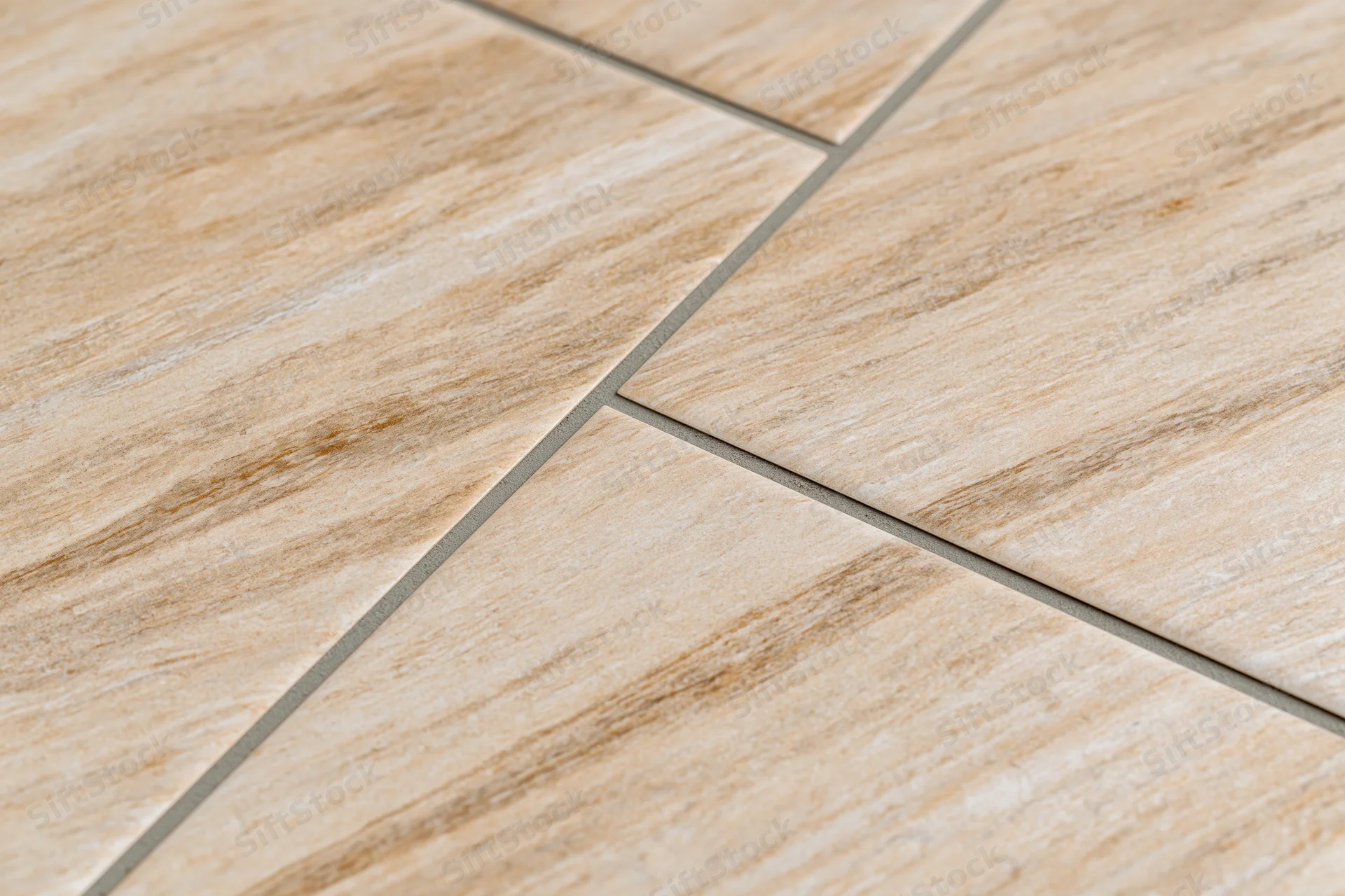 Diagonal ceramic floor tiles with wood grain pattern and grout lines on flat surface