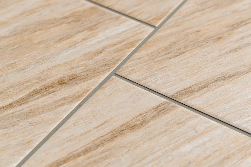 Diagonal ceramic floor tiles with wood grain pattern and grout lines on flat surface
