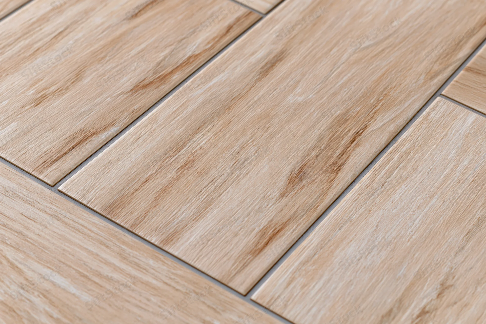 Diagonal ceramic floor tiles with wood grain pattern arranged in staggered layout on interior surface