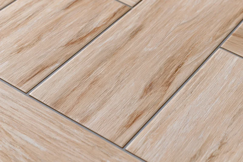 Diagonal ceramic floor tiles with wood grain pattern arranged in staggered layout on interior surface