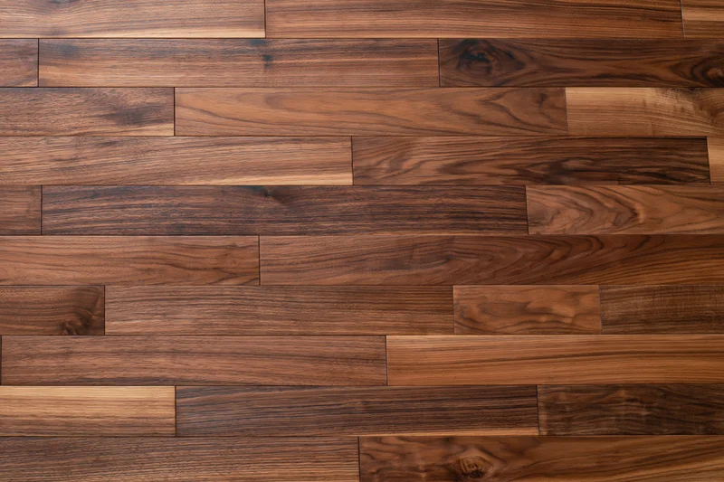 Close-up flat lay of dark walnut hardwood parquet flooring