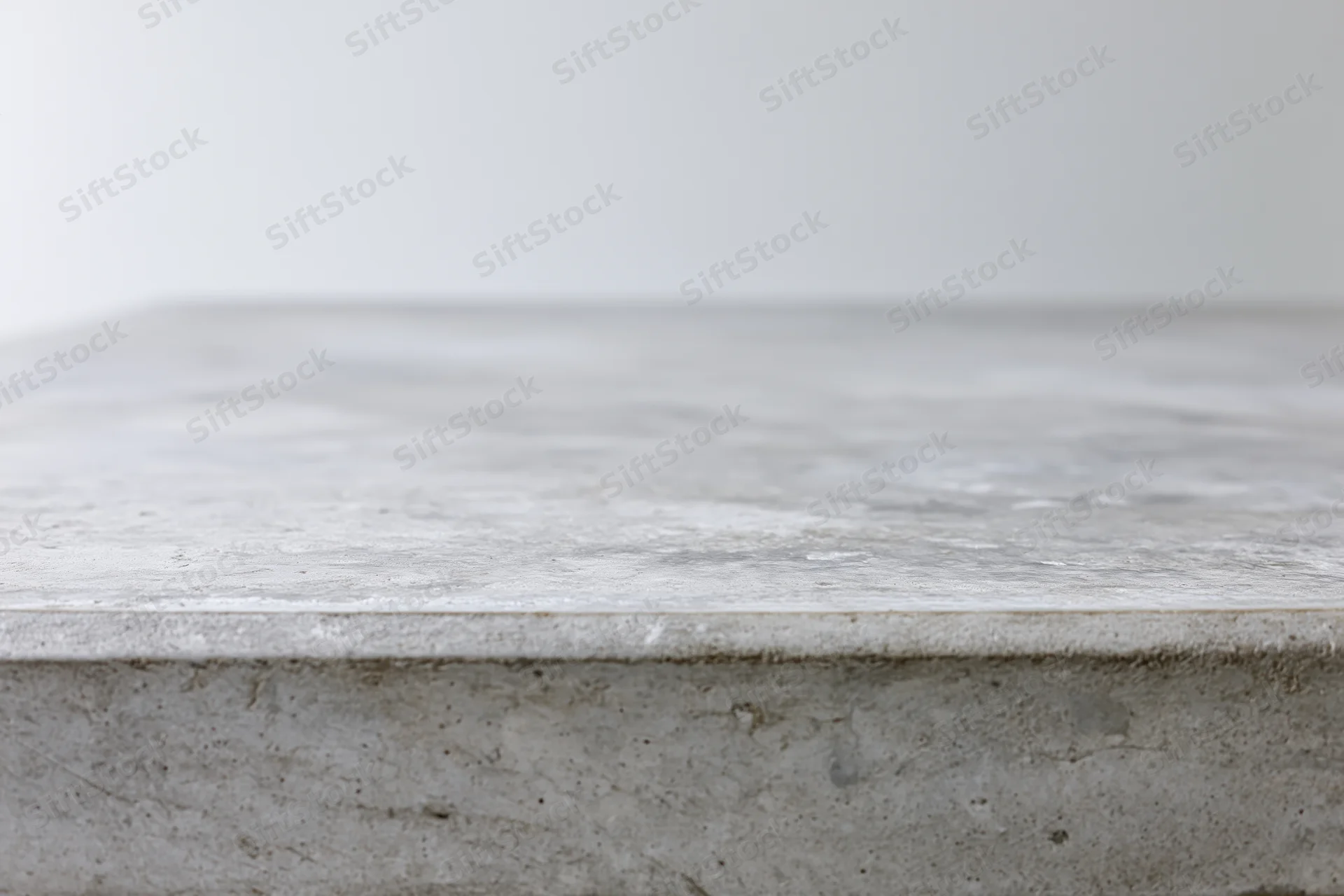 Empty concrete tabletop viewed straight on from low angle with copyspace