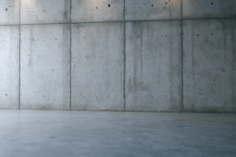 Empty concrete wall and floor interior with grid pattern and smooth surface