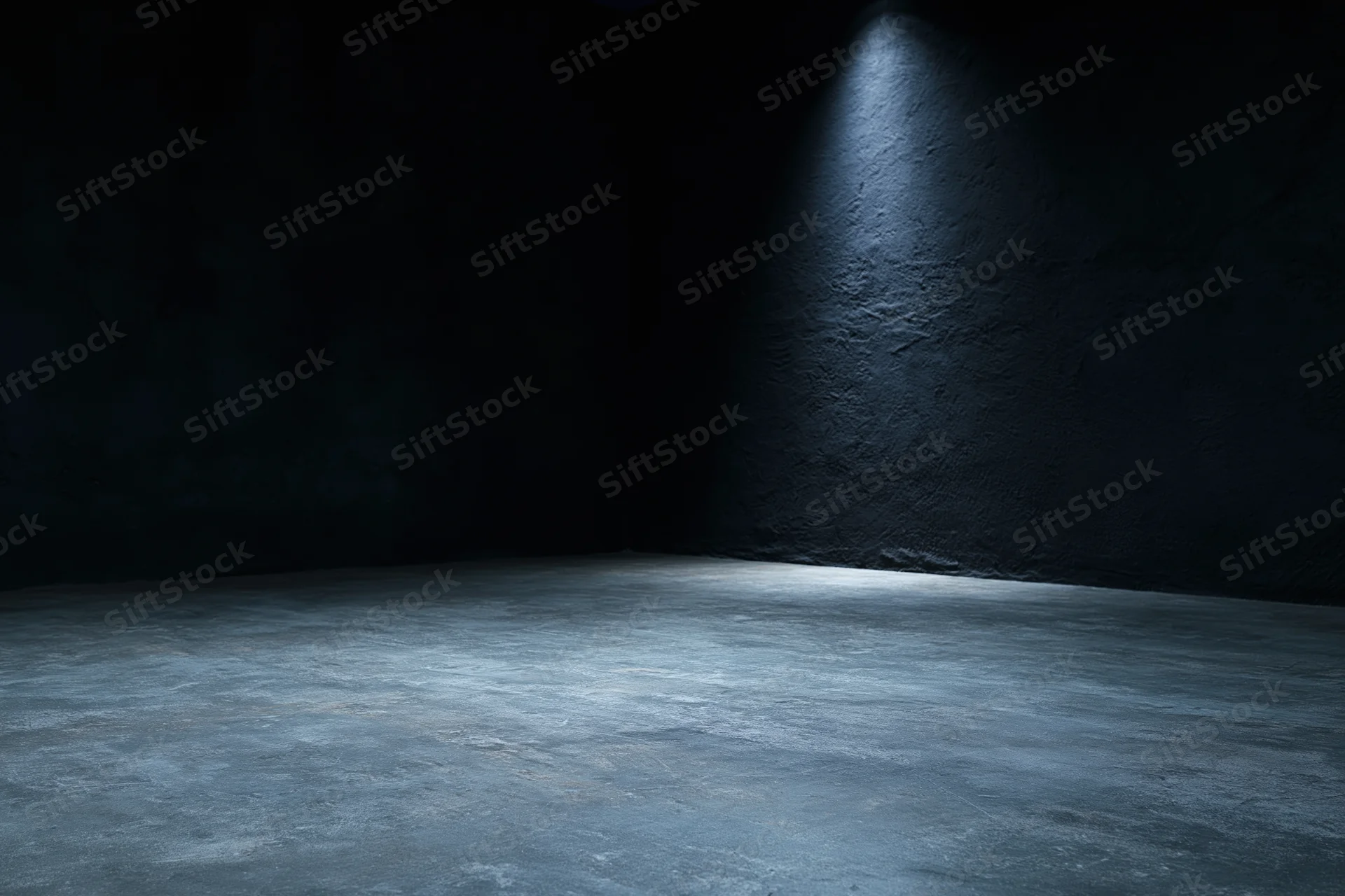 Empty dark studio interior with concrete floor and spotlight on rough wall