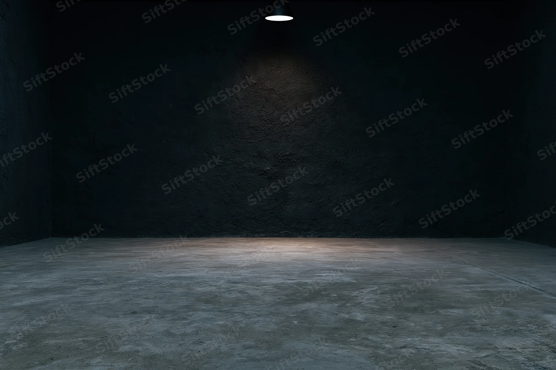 Empty dark studio interior with concrete floor and spotlight on rough wall