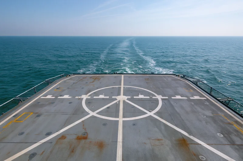 Empty helicopter landing pad on the stern deck of a naval ship at sea