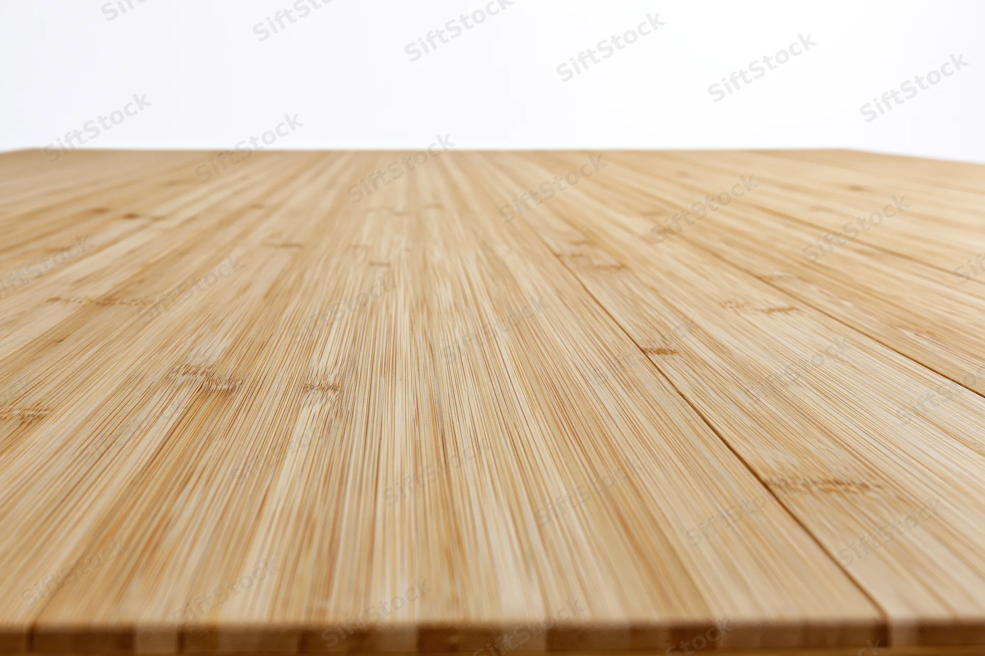 Light bamboo wood plank floor receding into perspective with horizontal grain pattern and natural texture